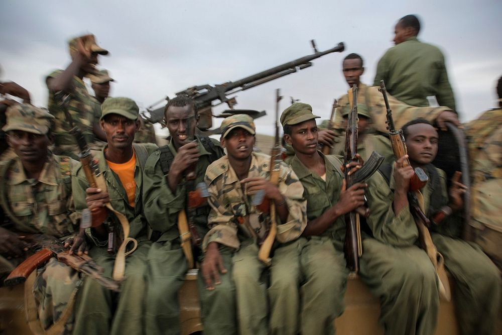 Fighters of the Ras Kimboni Brigade, a Somali government-allied militia are seen riding on the back of a machine-gun-mounted…