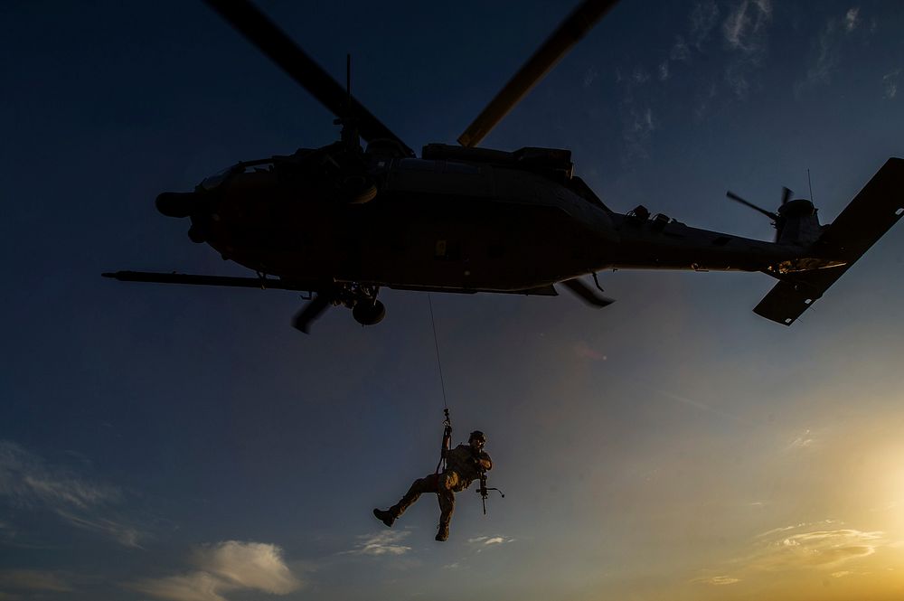 A U.S. Air Force pararescueman is lowered from an HH-60 Pave Hawk helicopter during a mission in Afghanistan Nov. 7, 2012.