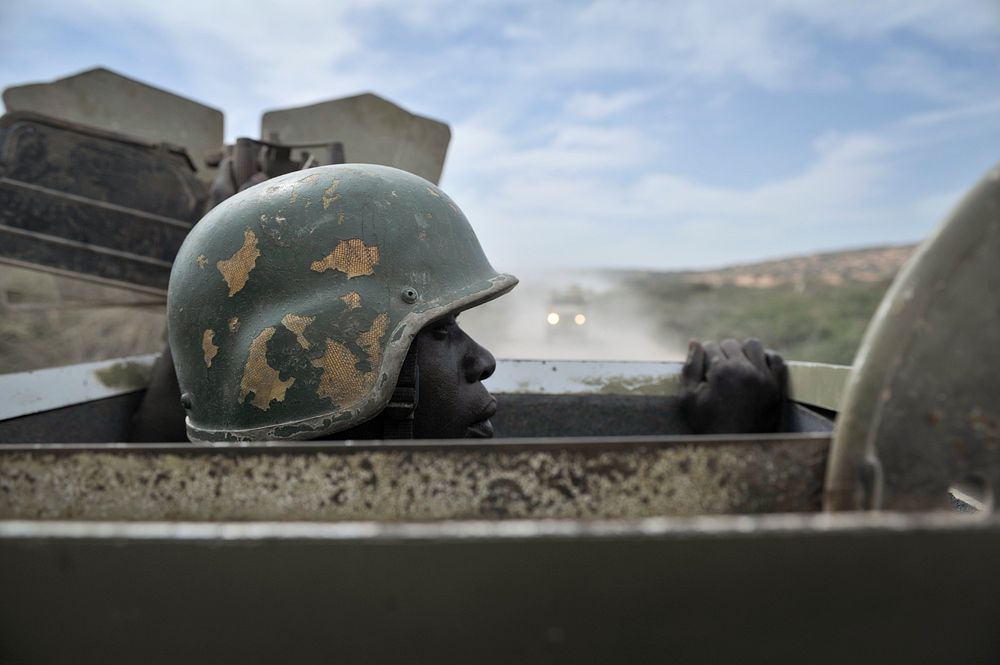 A soldier peers out of the top of an armored vehicle on a road just outside the city of Merca in Somalia on 2 February.