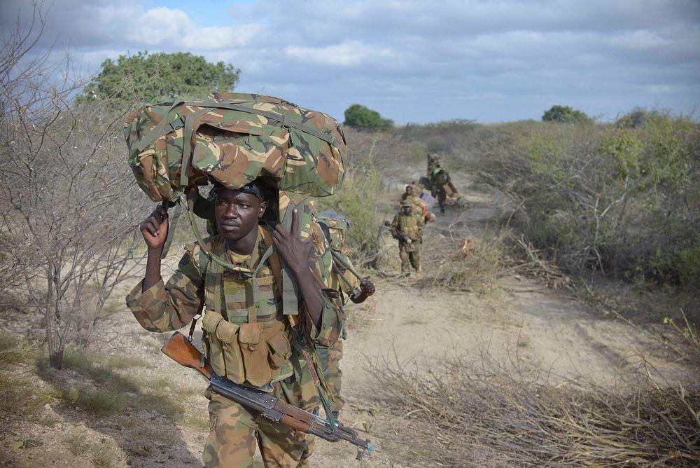 Ugandan soldiers, operating under the African Union Mission in Somalia (AMISOM), advance towards Buur-Hakba from their…