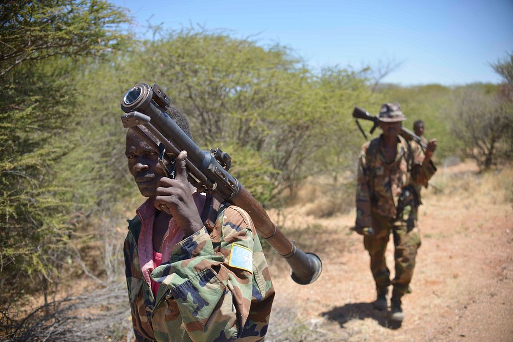 Two members of the Somali National Army (SNA) walk with their rocket propelled grenade (RPG) launchers during an advance on…
