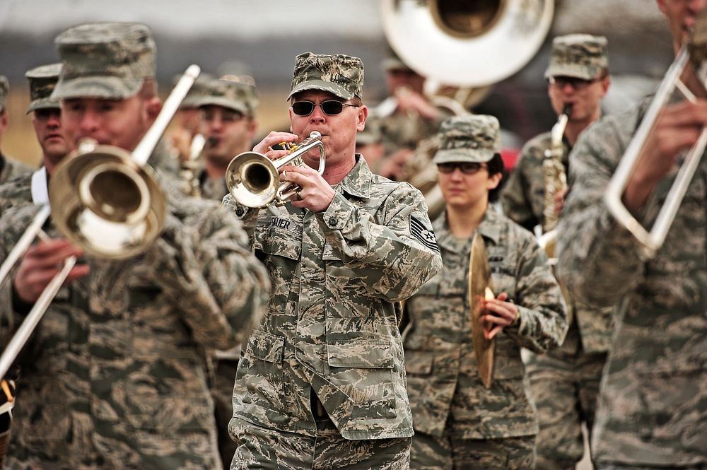 The U.S. Air Force Band of Mid-America marches outside as Marine Corps veteran Reggie Geggie, not pictured, guest of honor…