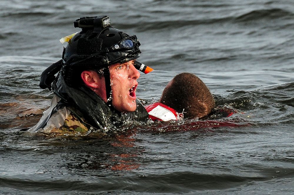 A U.S. Airman with the 23rd Special Tactics Squadron (STS) swims to a boat after rescuing a simulated crash victim at…