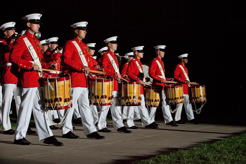 Members of the U.S. Marine Corps Drum and Bugle Corps perform during the Evening Parade at Marine Barracks Washington in…