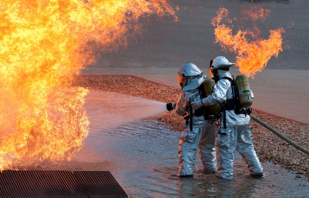 Two Mississippi Air National Guardsmen work to put out a fire at Volk Field Combat Readiness Training Center in Camp…