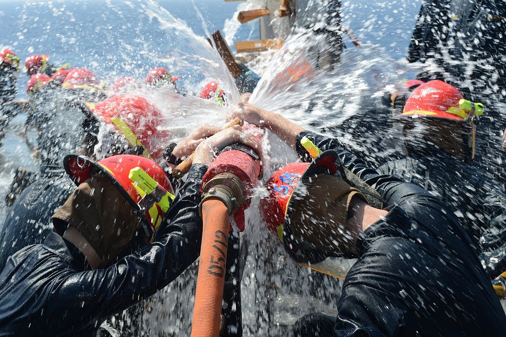 U.S. Sailors participate in pipe patching training during a general quarters drill July 12, 2013, aboard the amphibious…