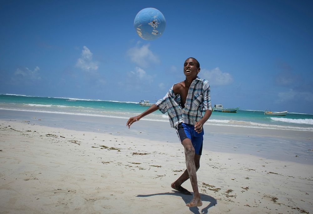 A Somali boy plays football on Lido Beach in the Kaaraan district of the Somali capital Mogadishu, 05 August, 2013.