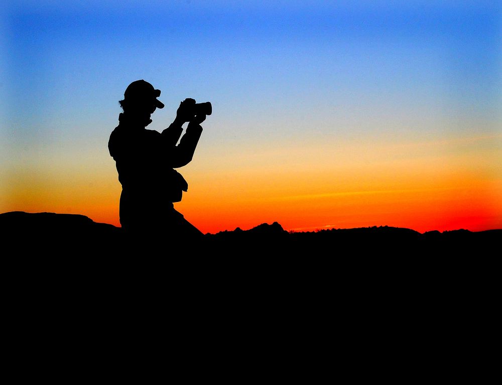 Photographer at sunset. (NPS photo by Kirsten Kearse). Original public domain image from Flickr