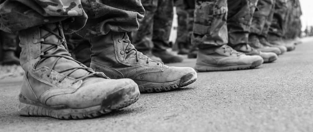 Afghan and coalition forces stand at parade rest as the names of fallen comrades are read during a memorial ceremony at…