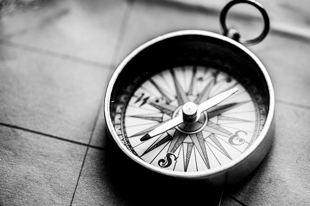 Adventure desktop wallpaper background, compass on map in black and white tone