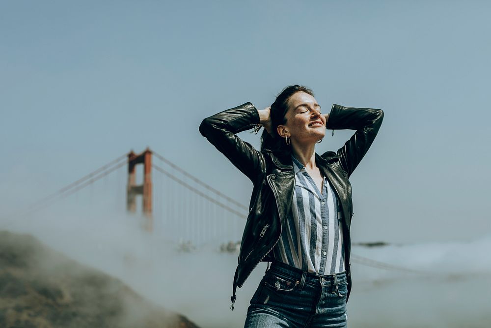 Happy woman at the Golden Gate Bridge, San Francisco, vivid tone