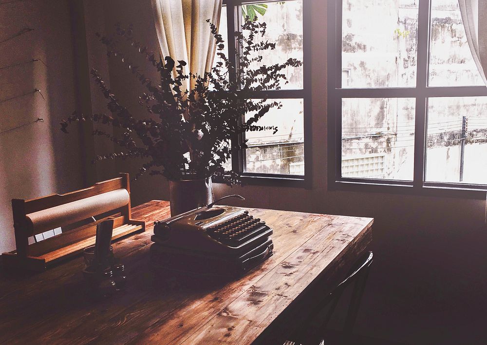 Typewriter on wooden table, warm tone