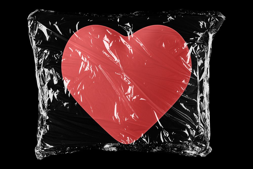 Heart in plastic, black background