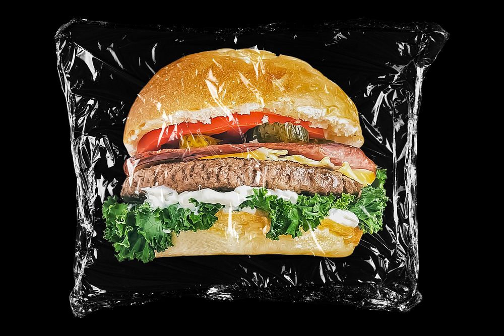 Hamburger in plastic, black background