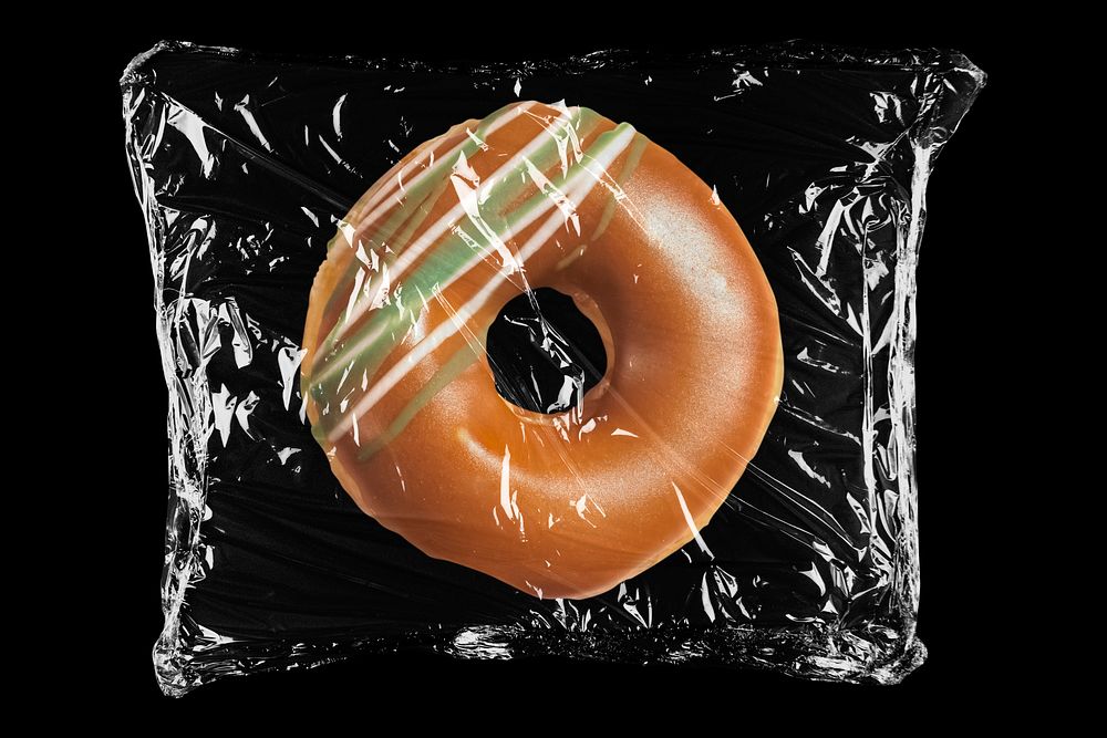 Donut in plastic, black background