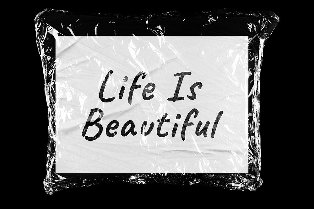 Life is beautiful plastic covered handwritten quote, black background