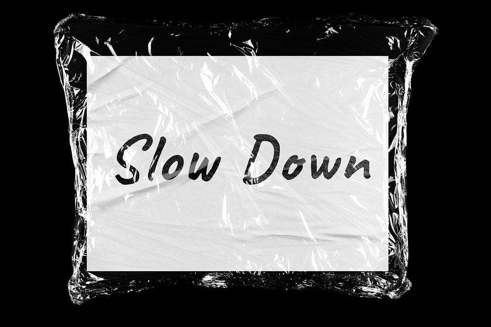 Slow down plastic covered handwritten message, black background