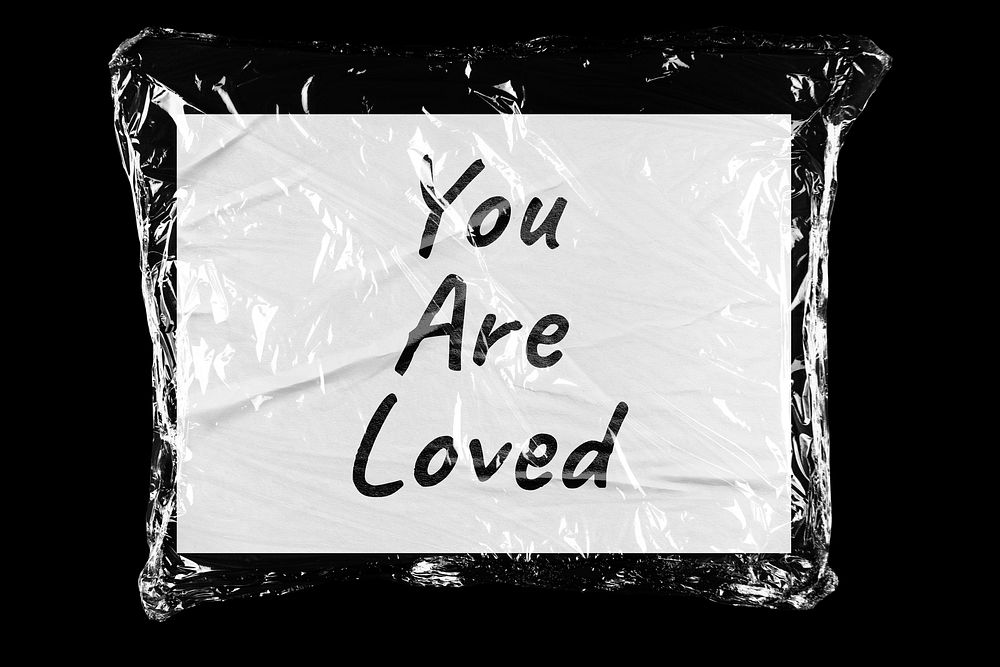 You are loved plastic covered handwritten quote, black background