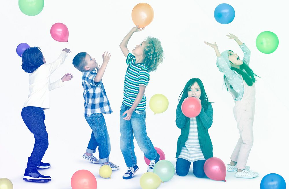 Young children playing with balloons