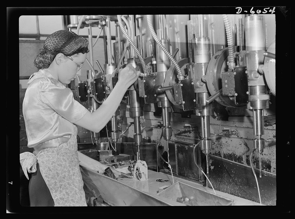 Women in war. Machine gun production operators. Operating a multiple drill press with speed and accuracy, this young woman…