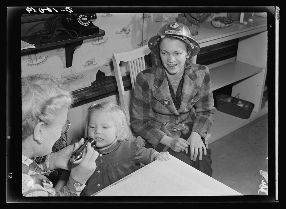 War workers' nursery. The morning checkup at modern nursery schools includes mouth and throat inspection. Mrs. Arlene…
