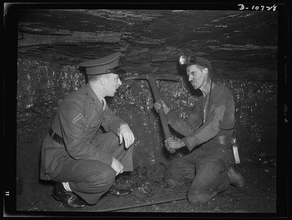 War production drive. Anthracite rallies. A soldier is shown how a miner swings a pick under a low ceiling in a Pennsylvania…
