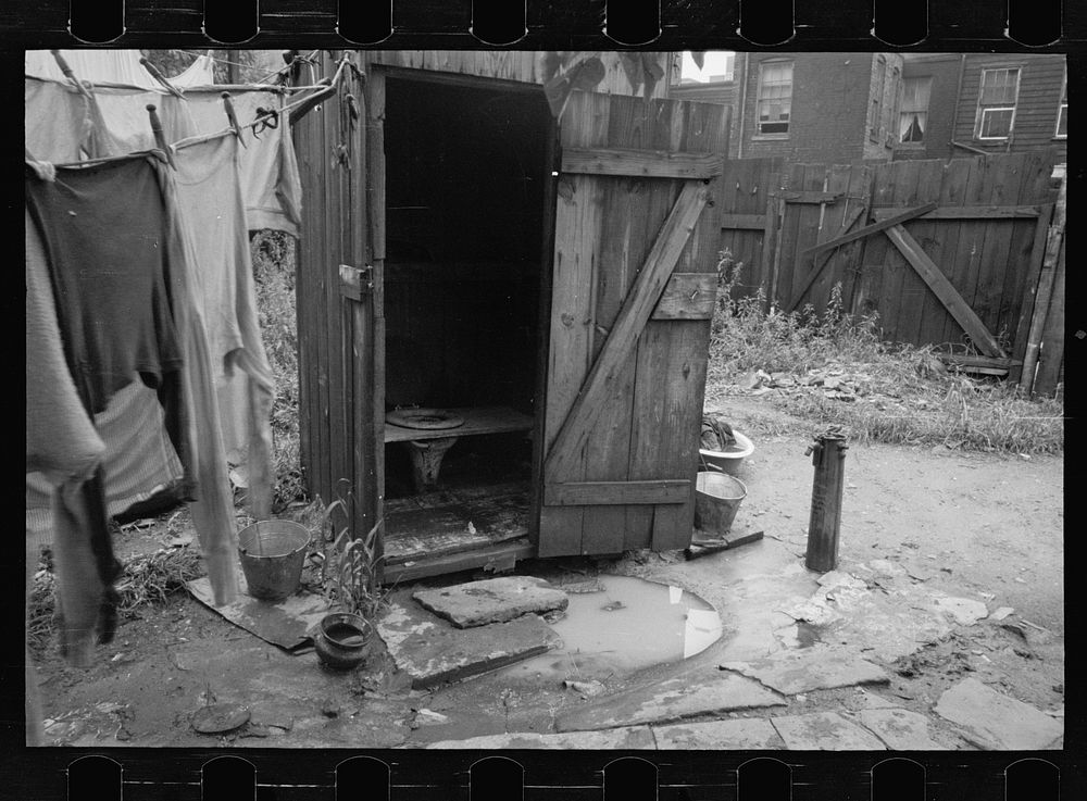 Backyard and privy near Government Printing Office, Washington, D.C. The pump on the right supplies water for the house back…