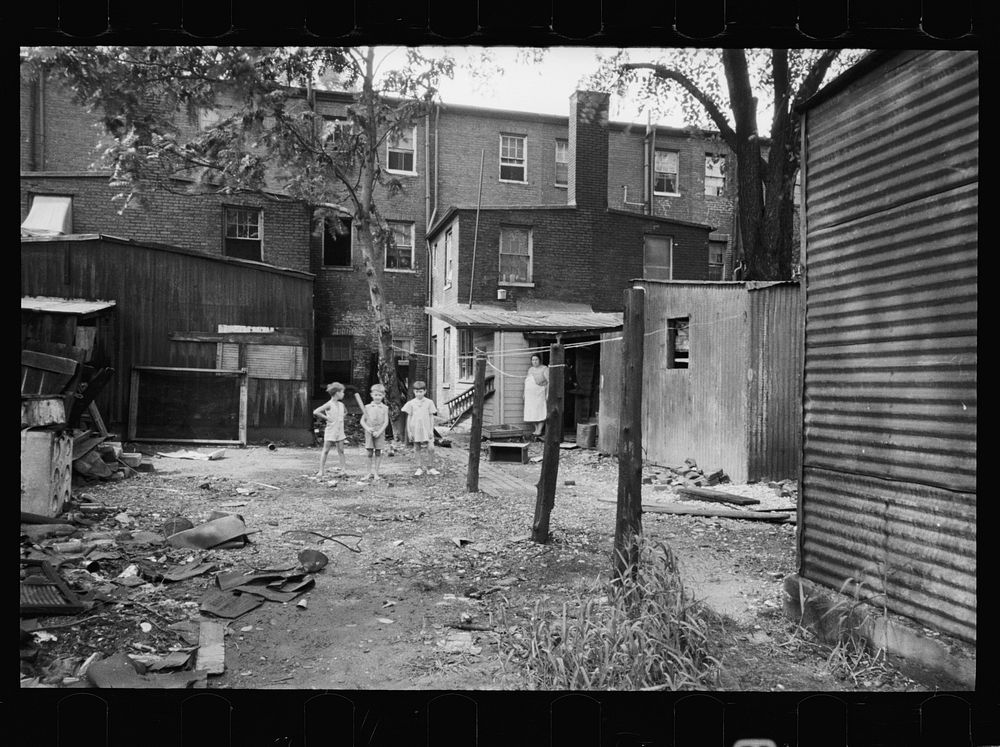 Children playing in backyard in slum area near capitol. This area inhabited by both white and , Washington, D.C.. Sourced…