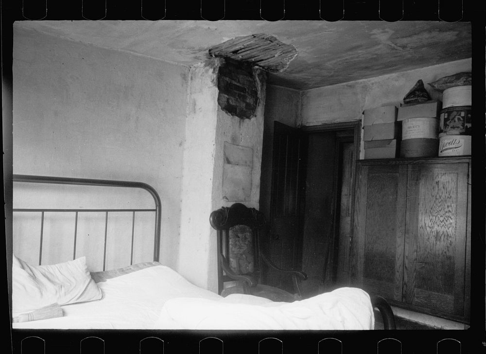Typical bedroom in  slum, Washington, D.C. A bed, one chair, and a possible bit of furniture for a bureau is usually the…
