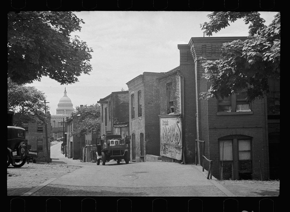 Slums near the Capitol, Washington, D.C. With the Capitol clearly in view, these houses exist under the most unsanitary…