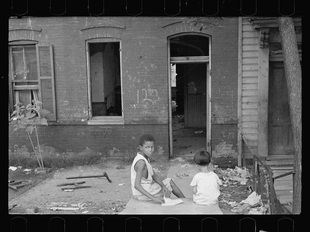 Slum front yard playground, Washington, D.C. Such is the front yard available to these two youngsters to play in. Sourced…