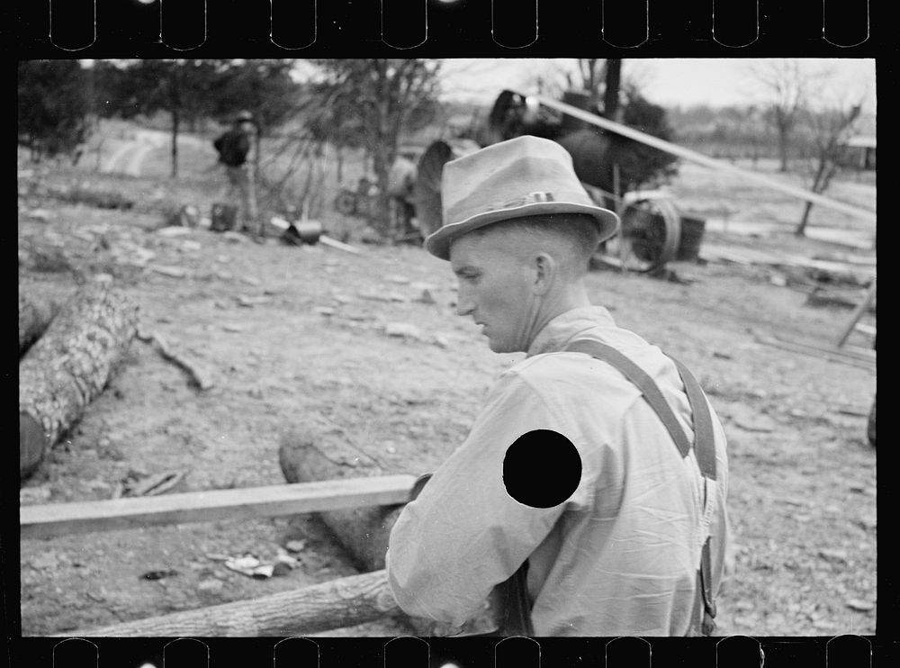 [Untitled photo, possibly related to: Splitting shingles with froe and maul on Coalins Project area farm, in western…