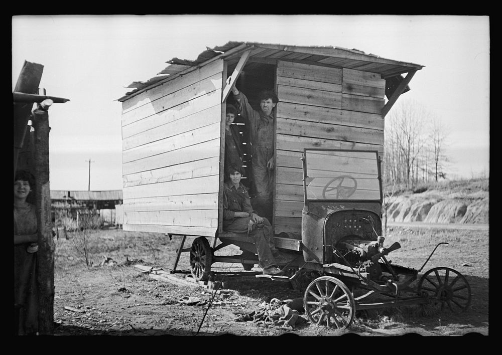 One-room hut housing family of nine built over chassis of abandoned Ford in open field between Camden and Bruceton…