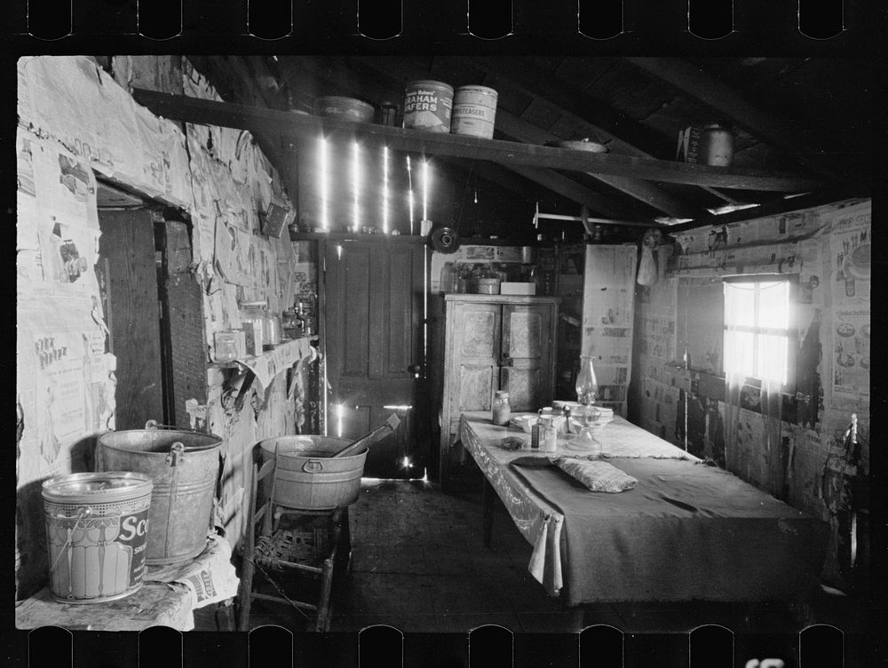Kitchen and washroom of two room mountain shack, Route U.S. 11, a few miles east of Marshall, North Carolina. Sourced from…