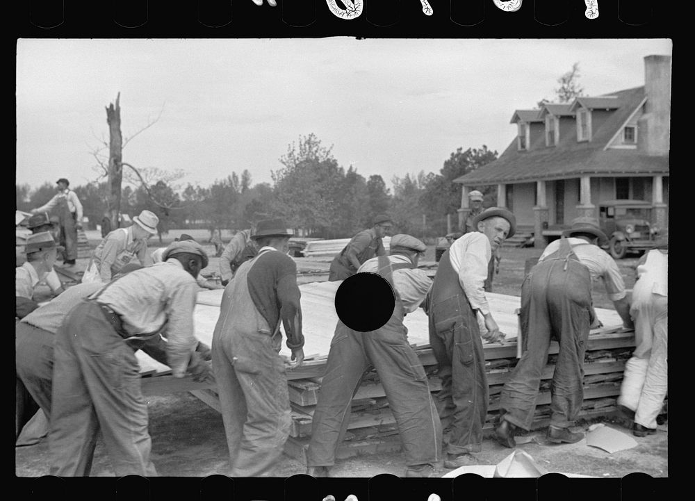 [Untitled photo, possibly related to: Loading wall of prefabricated house onto truck, Roanoke Farms, North Carolina].…