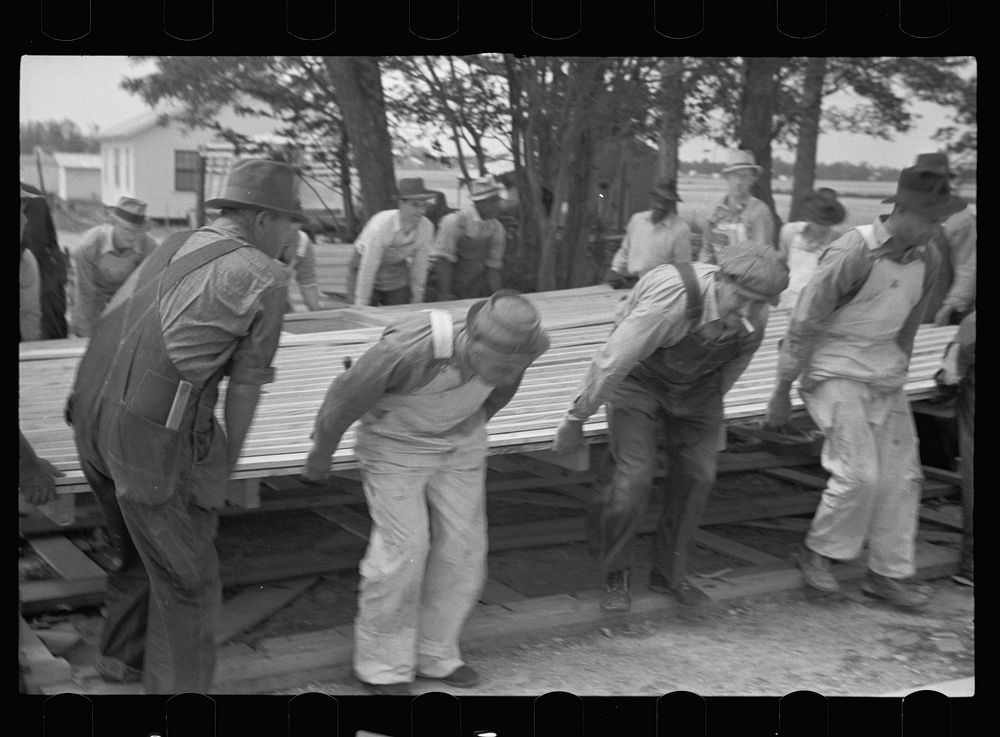 [Untitled photo, possibly related to: Loading wall of prefabricated house onto truck, Roanoke Farms, North Carolina].…