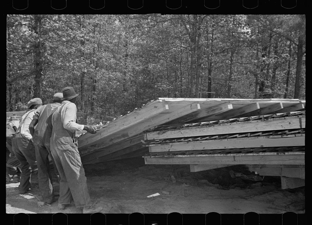 Unloading wall of prefabricated house from truck, Roanoke Farms Project, North Carolina. Sourced from the Library of…