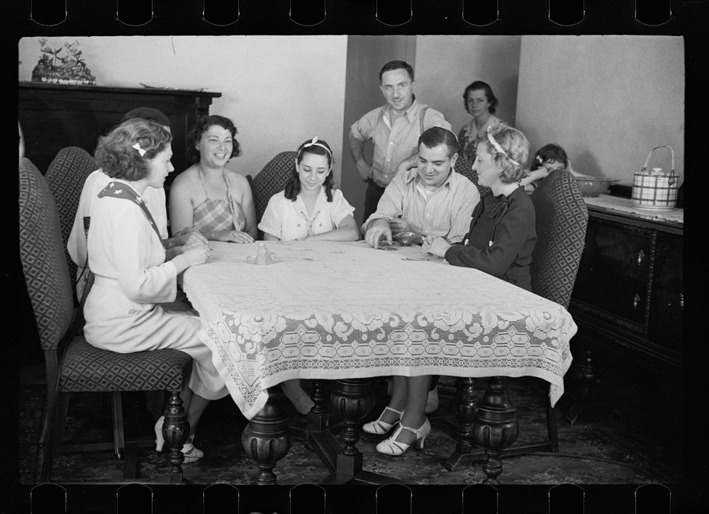 [Untitled photo, possibly related to: Family group playing cards in one of the new homes on the Hightstown Project, New…