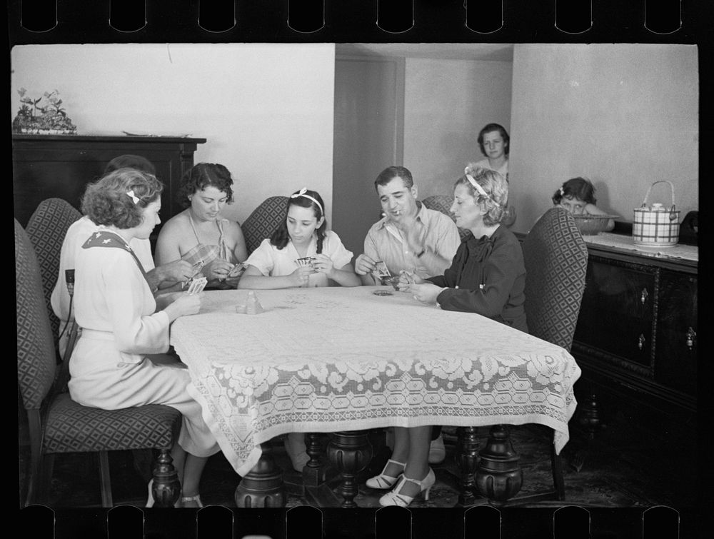 [Untitled photo, possibly related to: Family group playing cards in one of the new homes on the Hightstown Project, New…