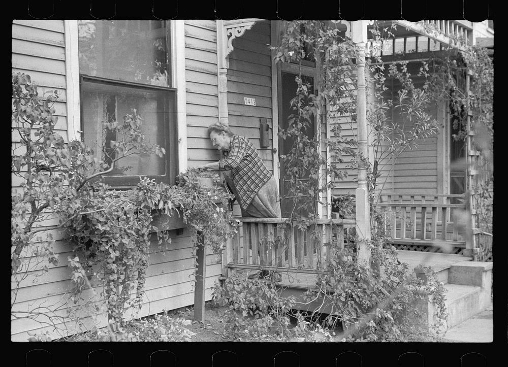 Lady tending her flower box, Omaha, Nebraska. Sourced from the Library of Congress.