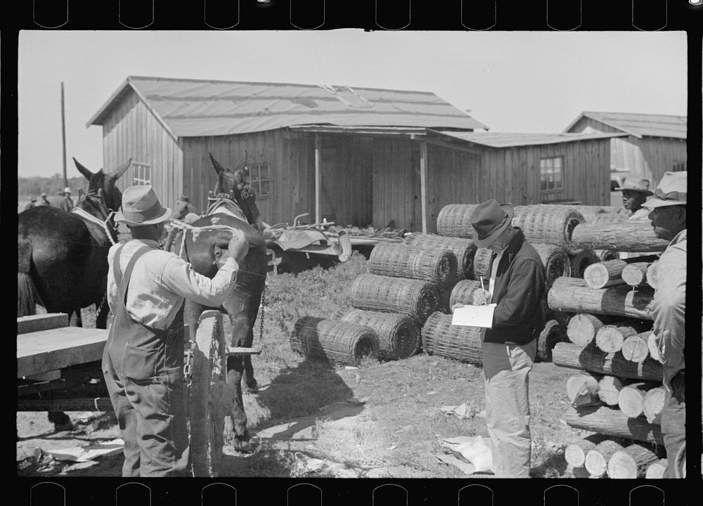 Foreman checking out supplies as they are received by es of the Roanoke Farms Project, North Carolina. Sourced from the…