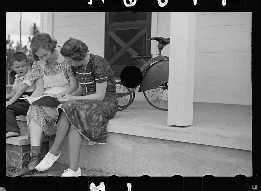 [Untitled photo, possibly related to: Home supervisor showing Mrs. Pope how to keep account book, Irwinville Farms…