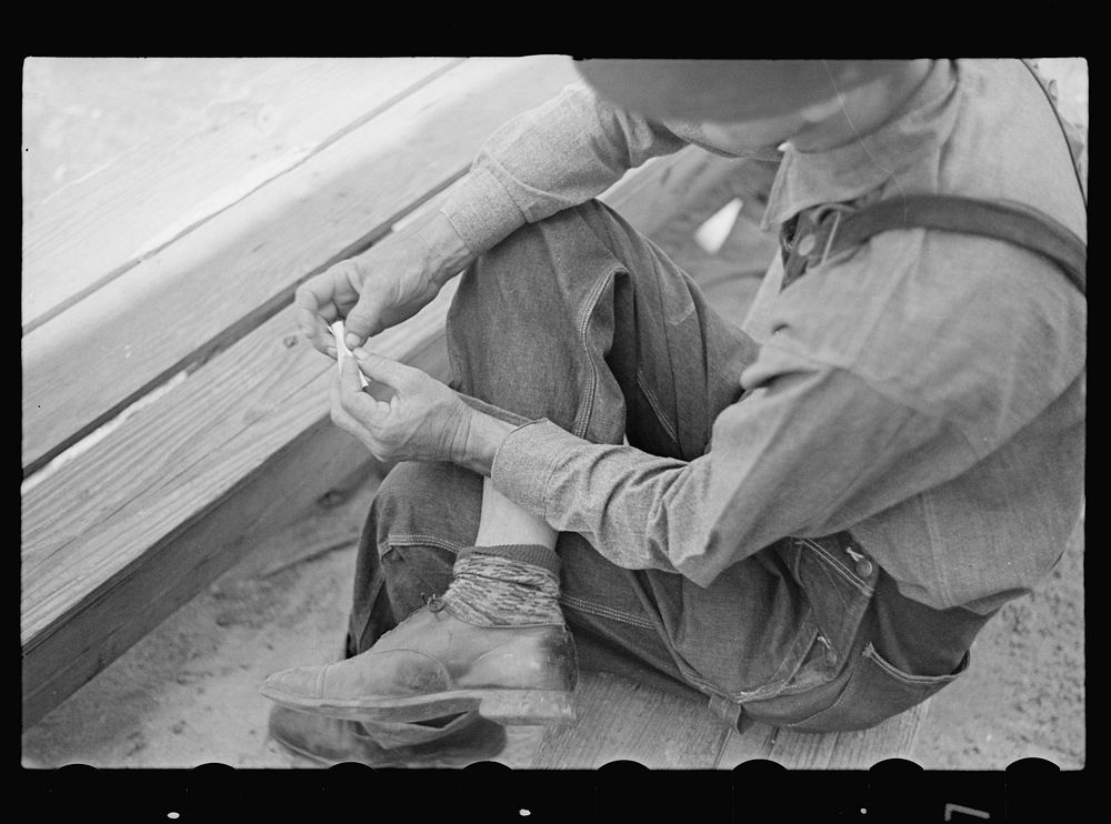 Rolling a cigarette. Irwinville Farms, Georgia. Sourced from the Library of Congress.