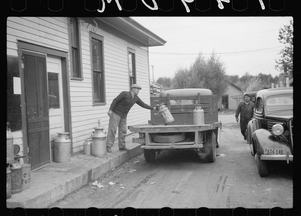 [Untitled photo, possibly related to: Unloading milk cans at cooperative creamery which has received a loan from the FSA…