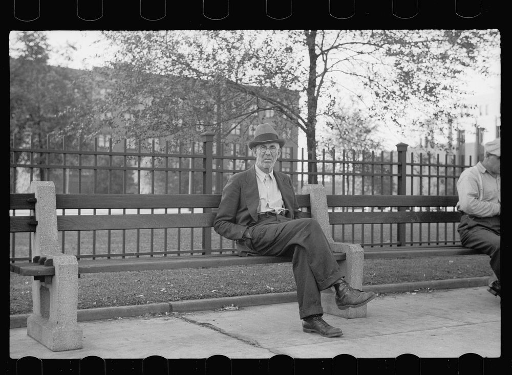 Man on park bench, Gateway District, Minneapolis, Minnesota. Sourced from the Library of Congress.