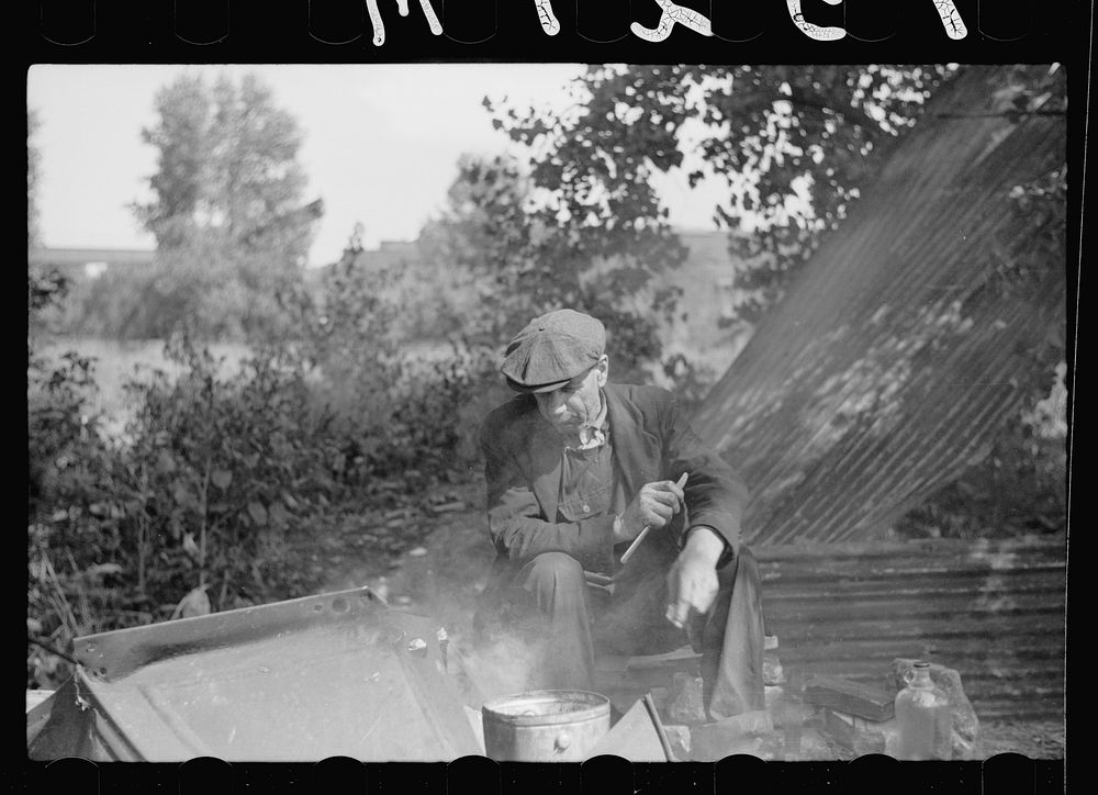 [Untitled photo, possibly related to: Man in hobo jungle killing turtle to make soup, Minneapolis, Minnesota]. Sourced from…
