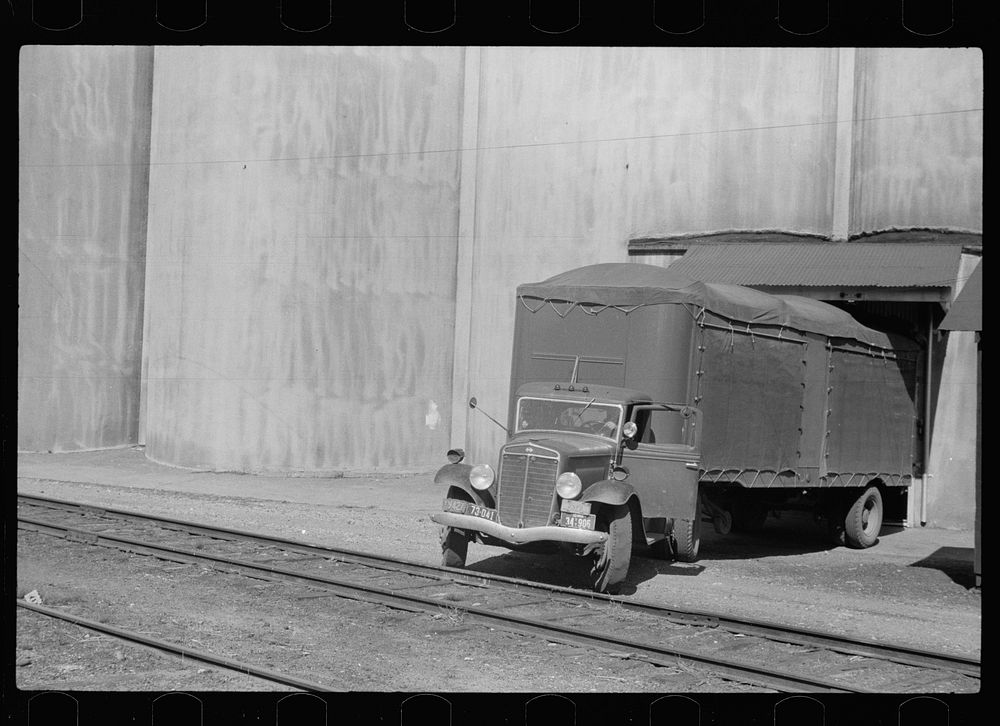 Truck unloading wheat at grain elevator, Minneapolis, Minnesota. Sourced from the Library of Congress.