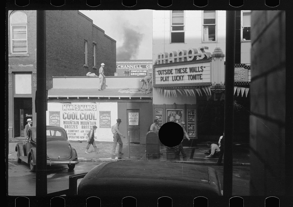 [Untitled photo, possibly related to: Movie theatre, Elkins, West Virginia. There are two movies in town, both offer games…