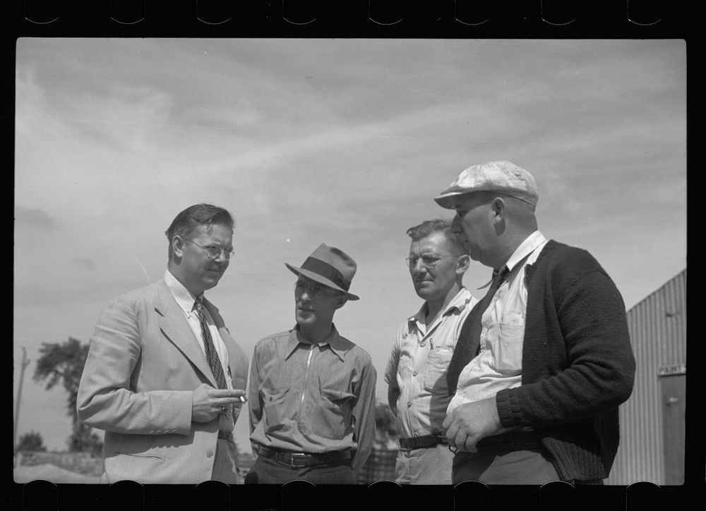 Assistant community manager talking with members of maintenance crew, Greendale, Wisconsin. Sourced from the Library of…