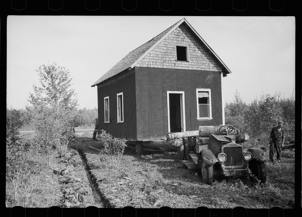 Farmer of cut-over land moving house to new land. The government bought up the land on which he formerly farmed to take it…